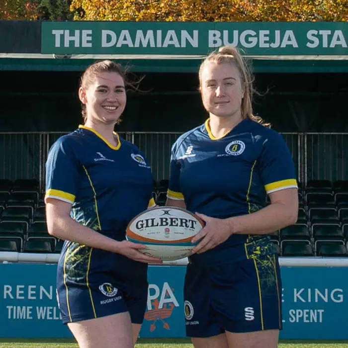 Two female rugby players with a ball