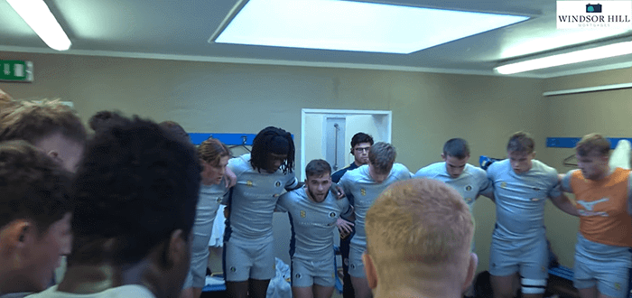 rugby players team chat in a changing room