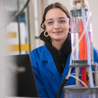 Emilie in her lab uniform