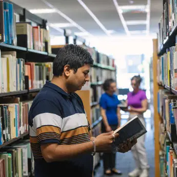 student-reading-book-in-library