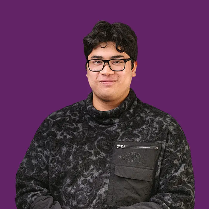 man in front of a dark purple background
