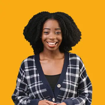 smiling woman in fromt of a yellow background