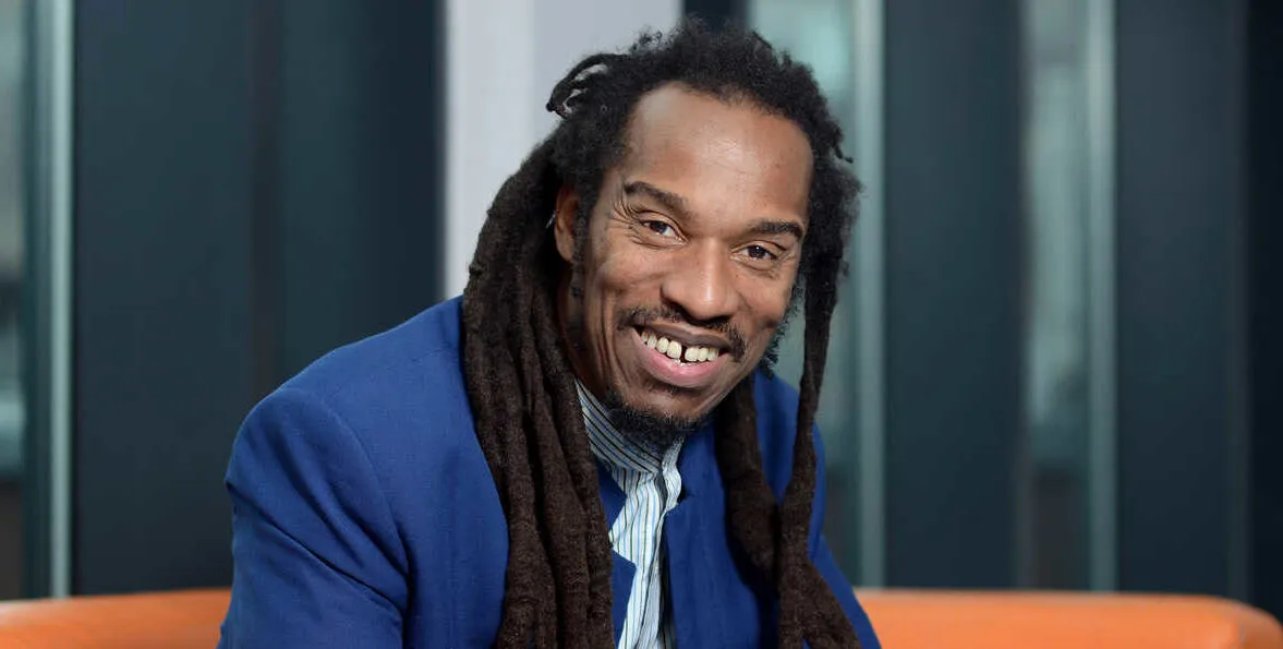 Benjamin Zephaniah on orange sofa