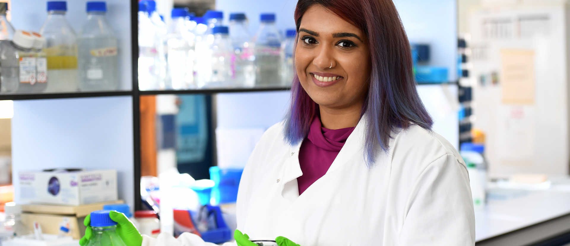 PhD Biosciences student in a lab banner