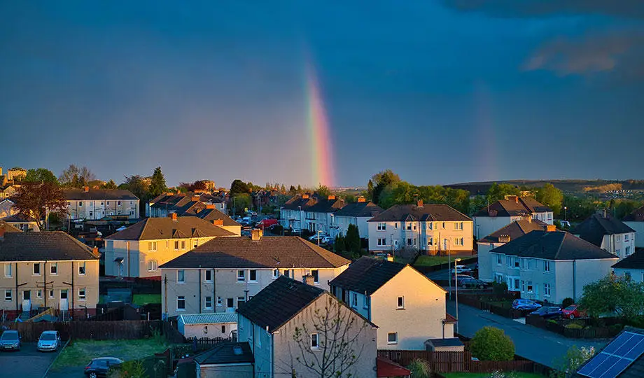 Envato-rainbow-spanning-the-sky-over-a-bustling-urban-lan-920