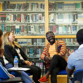 male lecturer with a group of student in the Library of Brunel University London(1)