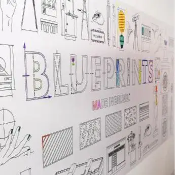 A wall with hand-drawn illustrations and the word "BLUEPRINTS" in bold, colourful letters.