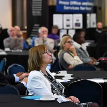 Audience members sitting and watching the Research Institute showcase