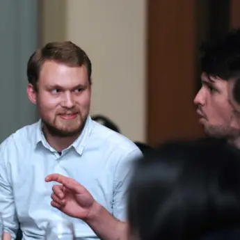 two people talking at the Graduate School research reception