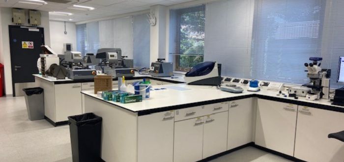 A clean, modern laboratory with equipment and a window on the far end.