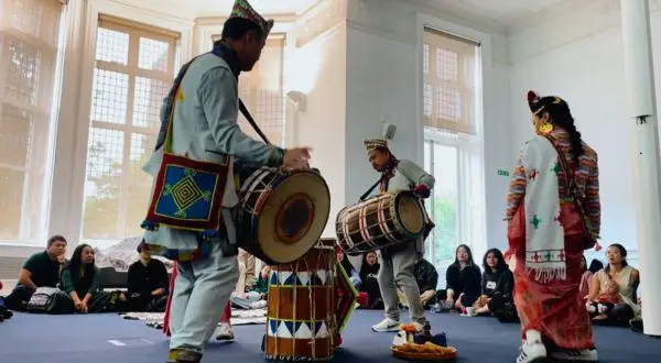 Performers with traditional clothing and drums at the Storytelling through dancing event