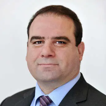 Portrait photo of Professor Hussam Jouhara, a man in a suit with a blue shirt and patterned tie