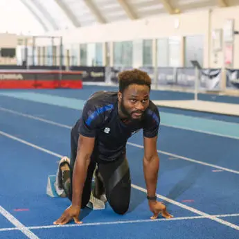 male student in IAC ready to run on a track