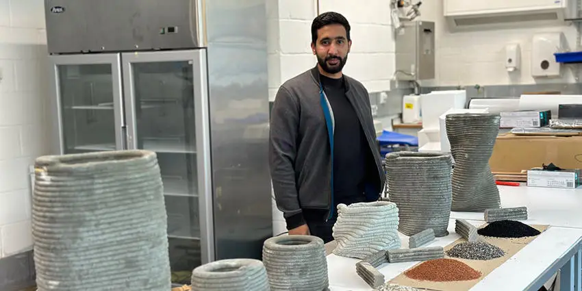 Dr Abdulrahman Albar with different 3D printed concrete samples at a table