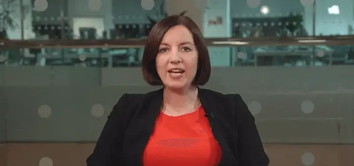 Photo of Bridget Phillipson the Secretary of State for Education in the UK, a woman in black blazer and red top in an indoor setting.